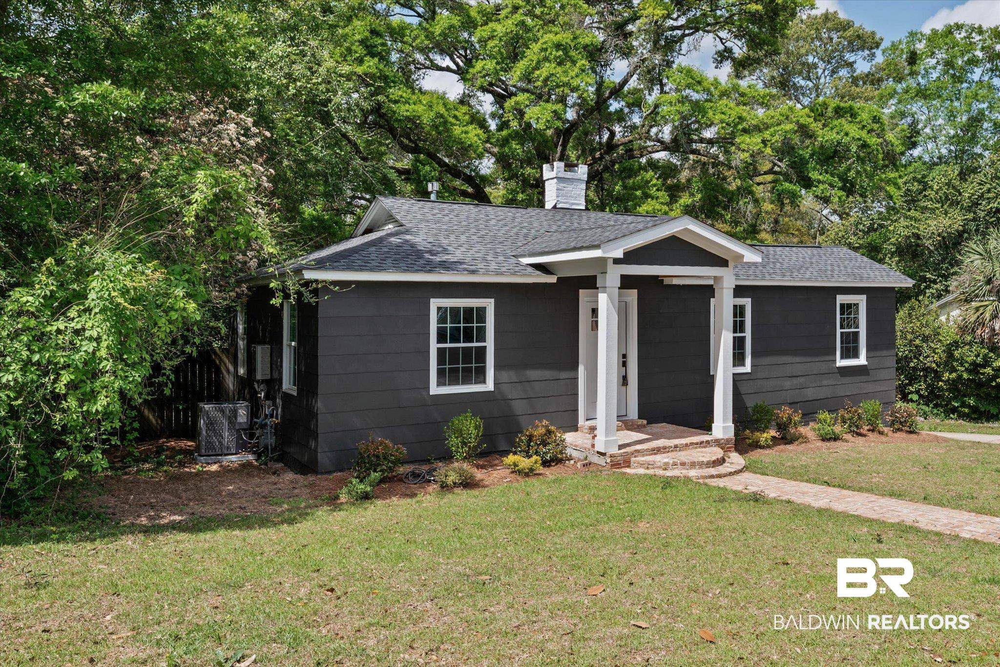 41 Hathaway Road West Mobile, AL 36608 - Photo 21 of 24 Ranch-style home with a shingled roof, a chimney, a front yard, and view of wooded area