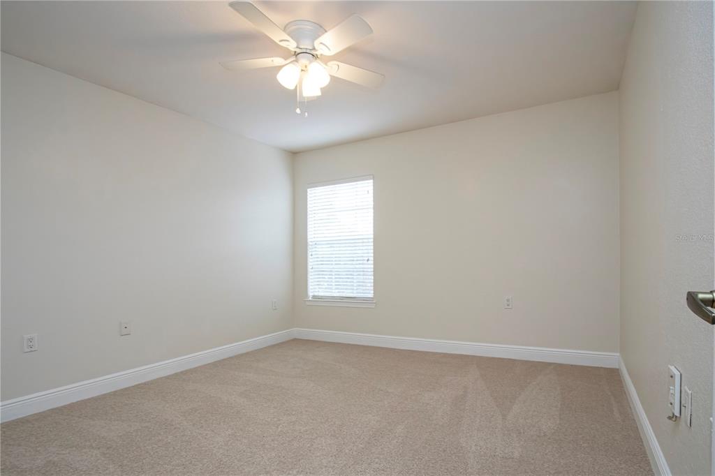 8926 Manor Loop, Unit 107 Lakewood Ranch, FL 34202 - Photo 13 of 44 an empty room with a window and a fan