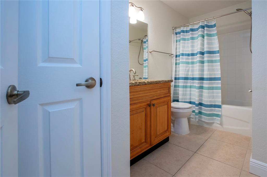 8926 Manor Loop, Unit 107 Lakewood Ranch, FL 34202 - Photo 17 of 44 a bathroom with a shower toilet and sink