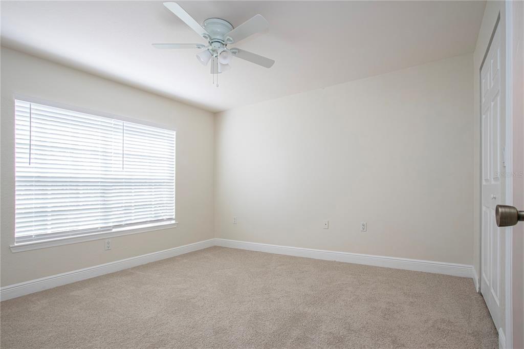 8926 Manor Loop, Unit 107 Lakewood Ranch, FL 34202 - Photo 21 of 44 an empty room with a window and a fan
