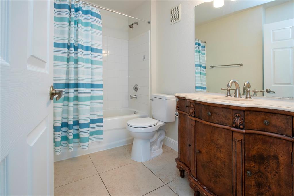 8926 Manor Loop, Unit 107 Lakewood Ranch, FL 34202 - Photo 25 of 44 a bathroom with a sink toilet and shower
