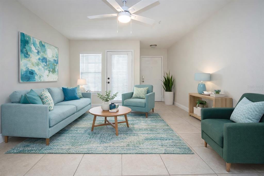 8926 Manor Loop, Unit 107 Lakewood Ranch, FL 34202 - Photo 27 of 44 a living room with furniture and a rug