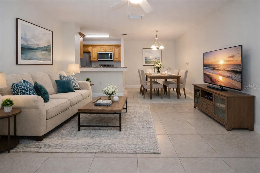 8926 Manor Loop, Unit 107 Lakewood Ranch, FL 34202 - Photo 30 of 44 a living room with furniture and a flat screen tv