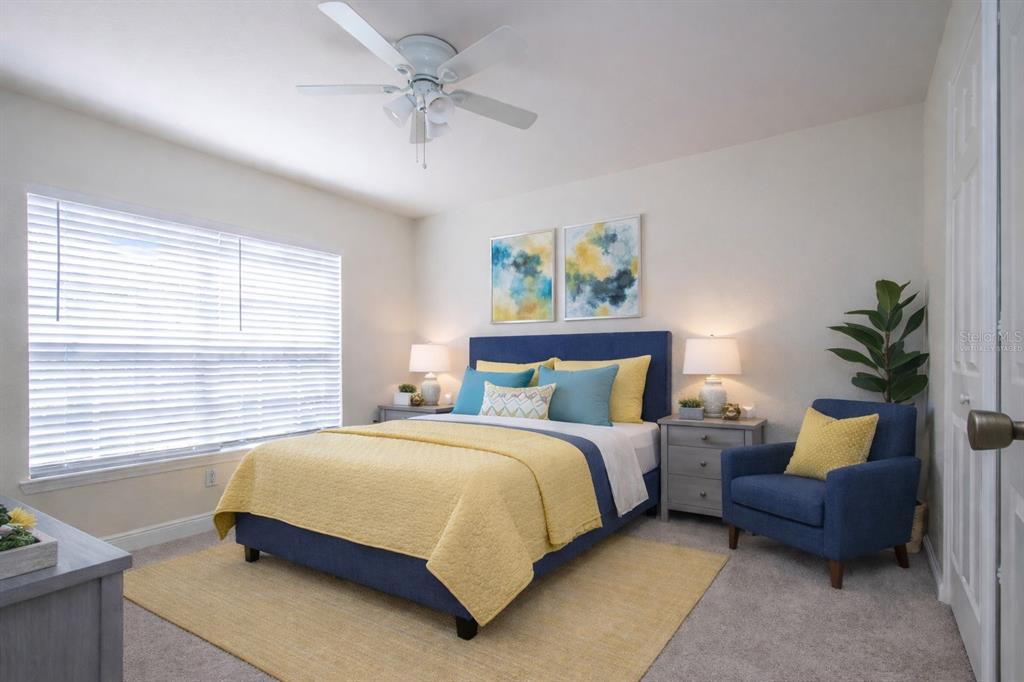 8926 Manor Loop, Unit 107 Lakewood Ranch, FL 34202 - Photo 31 of 44 a bedroom with a bed a couch and a potted plant