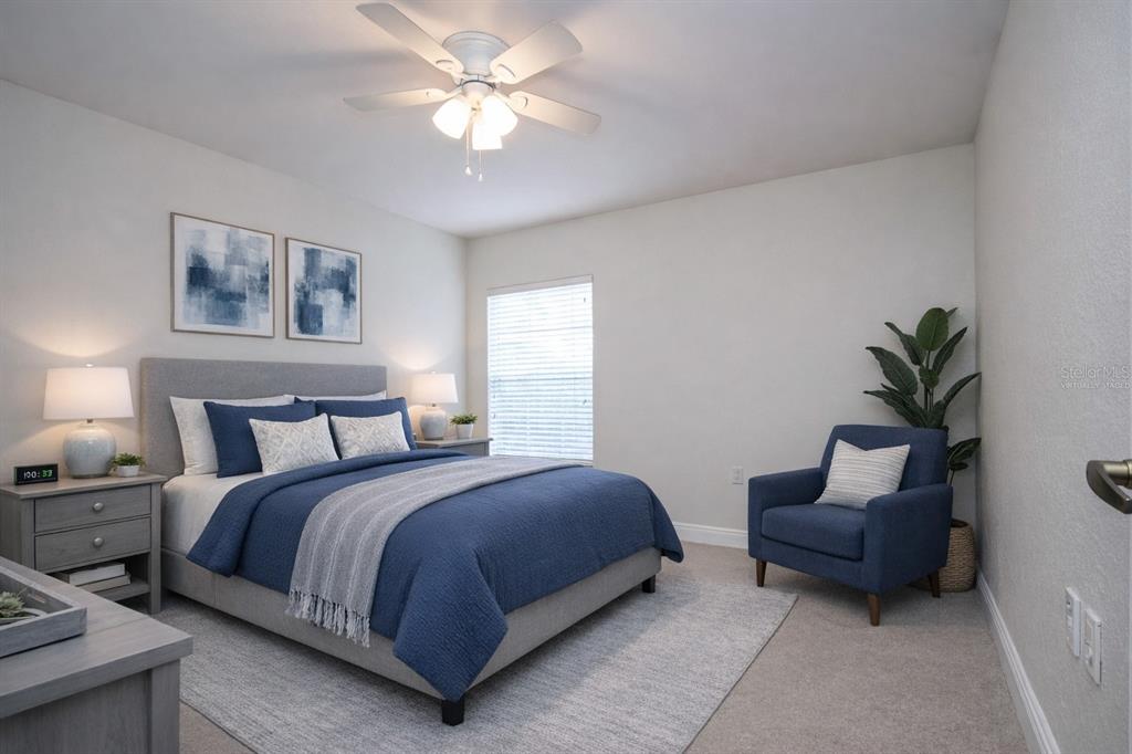 8926 Manor Loop, Unit 107 Lakewood Ranch, FL 34202 - Photo 32 of 44 a bedroom with a large bed and a couch