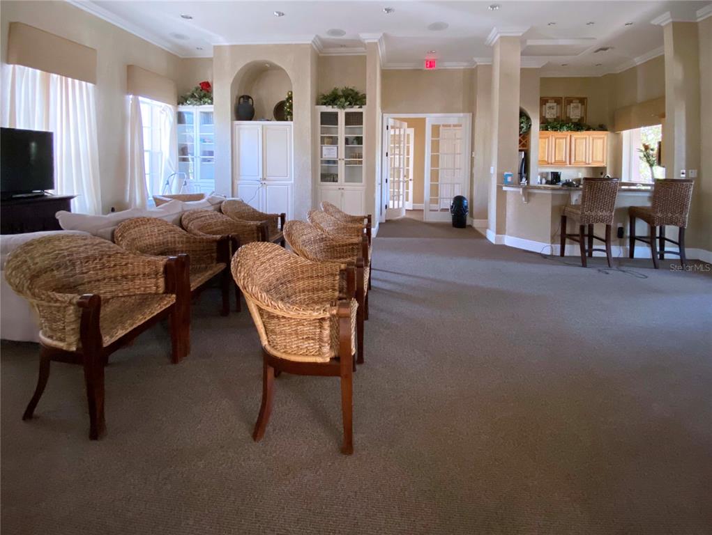 8926 Manor Loop, Unit 107 Lakewood Ranch, FL 34202 - Photo 37 of 44 a living room with furniture and a flat screen tv