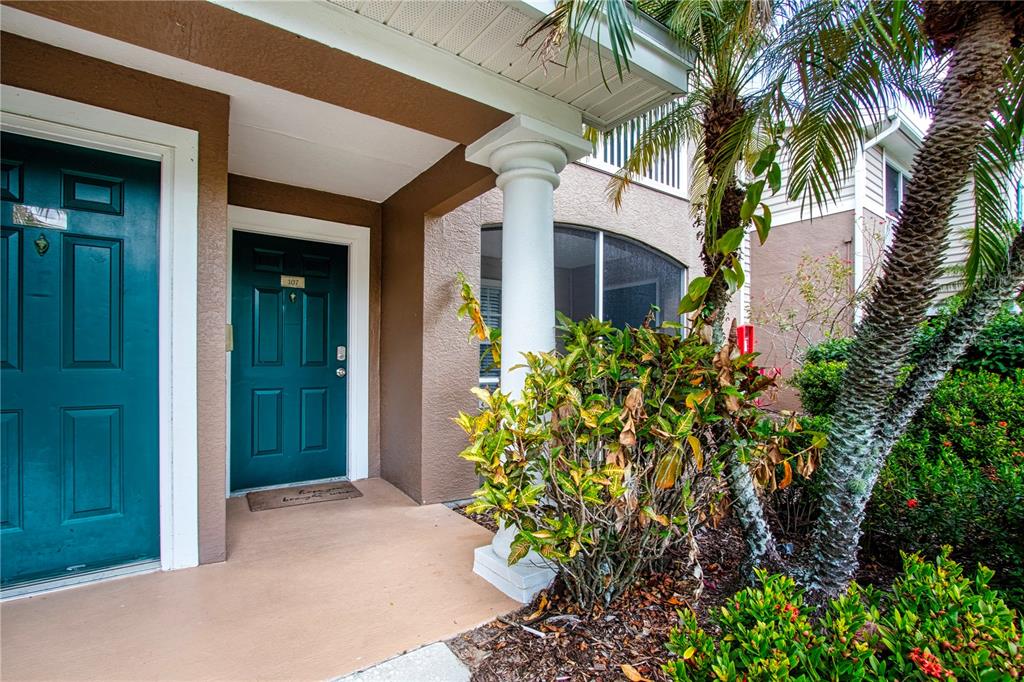8926 Manor Loop, Unit 107 Lakewood Ranch, FL 34202 - Photo 4 of 44 front view of a house with a plants