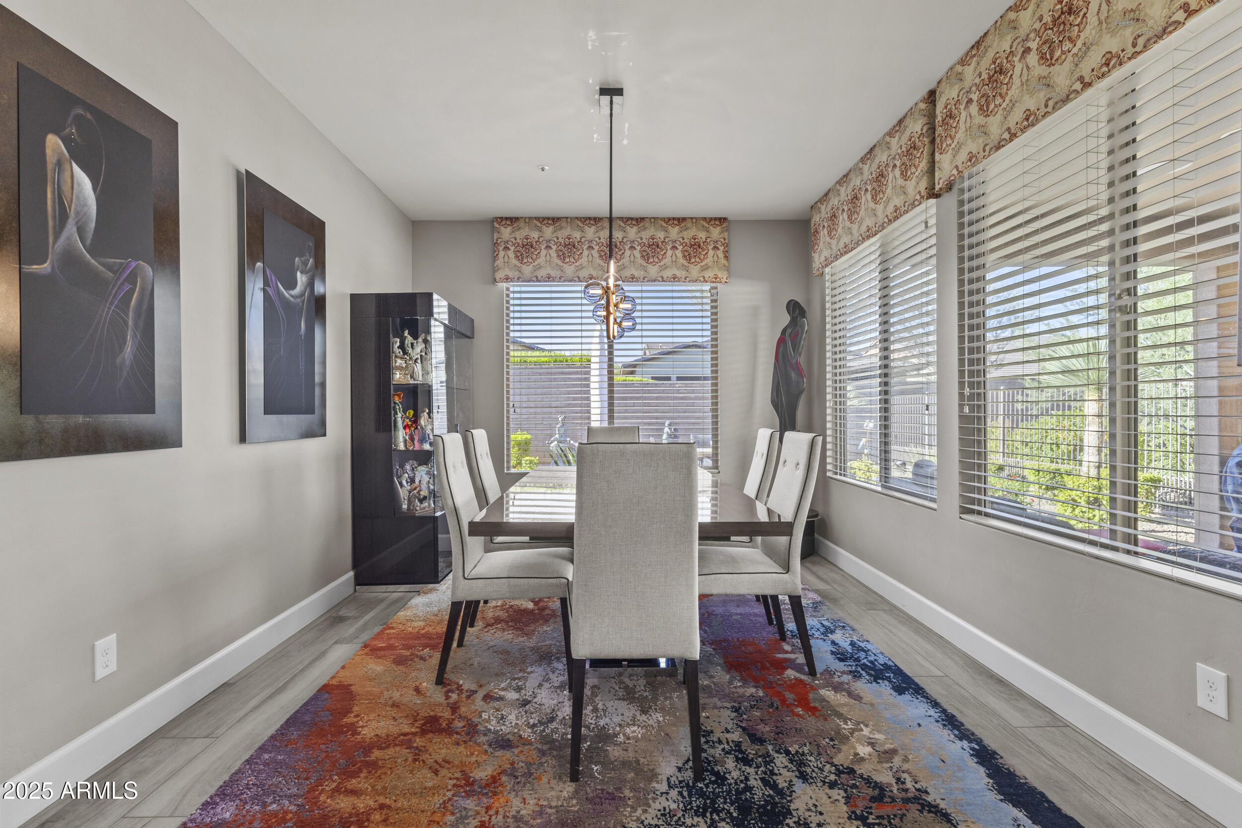 18068 East Curva De Plata Rio Verde, AZ 85263 - Photo 18 of 71 a dining room with furniture a chandelier and wooden floor