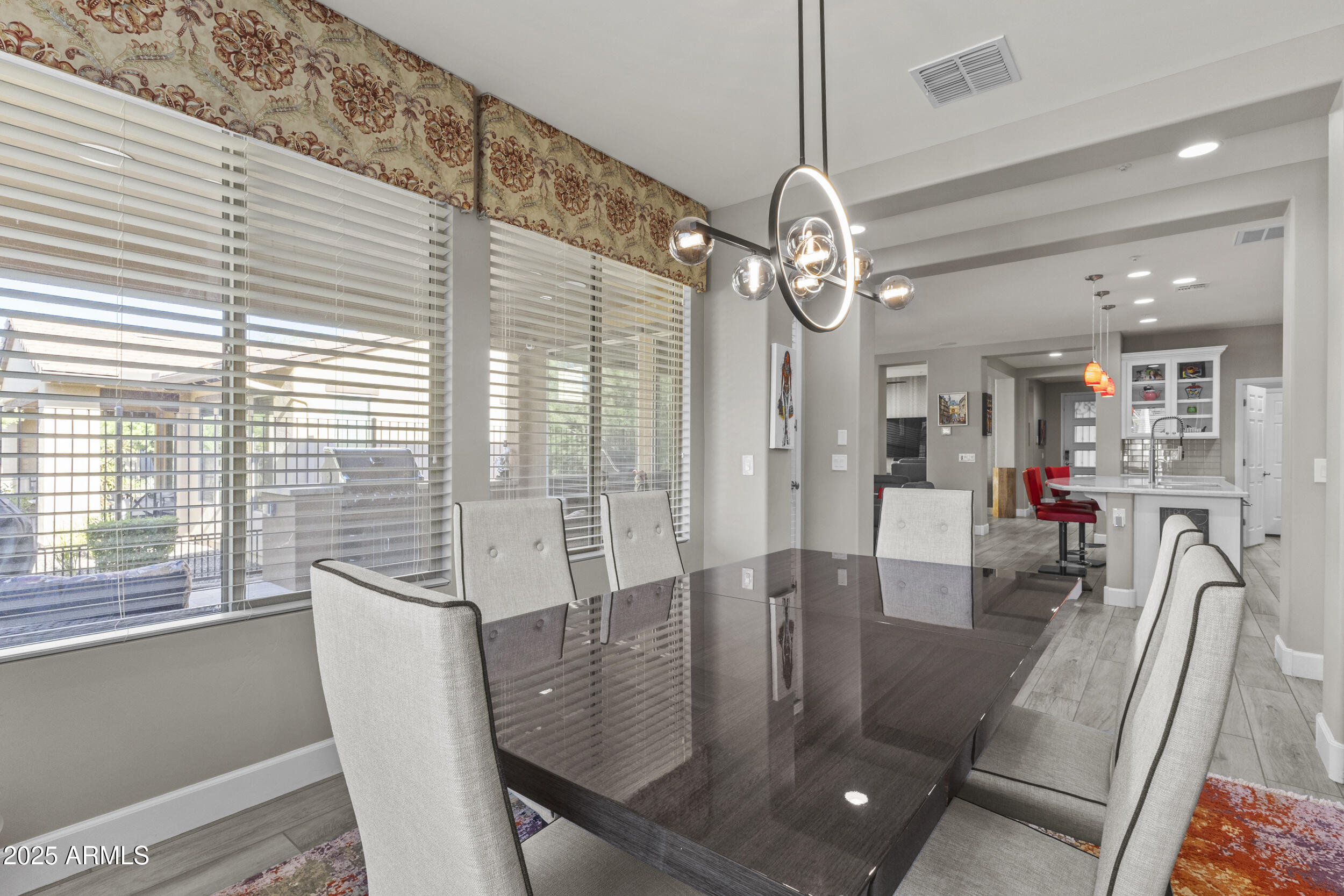 18068 East Curva De Plata Rio Verde, AZ 85263 - Photo 19 of 71 a view of a dining room with furniture wooden floor and chandelier