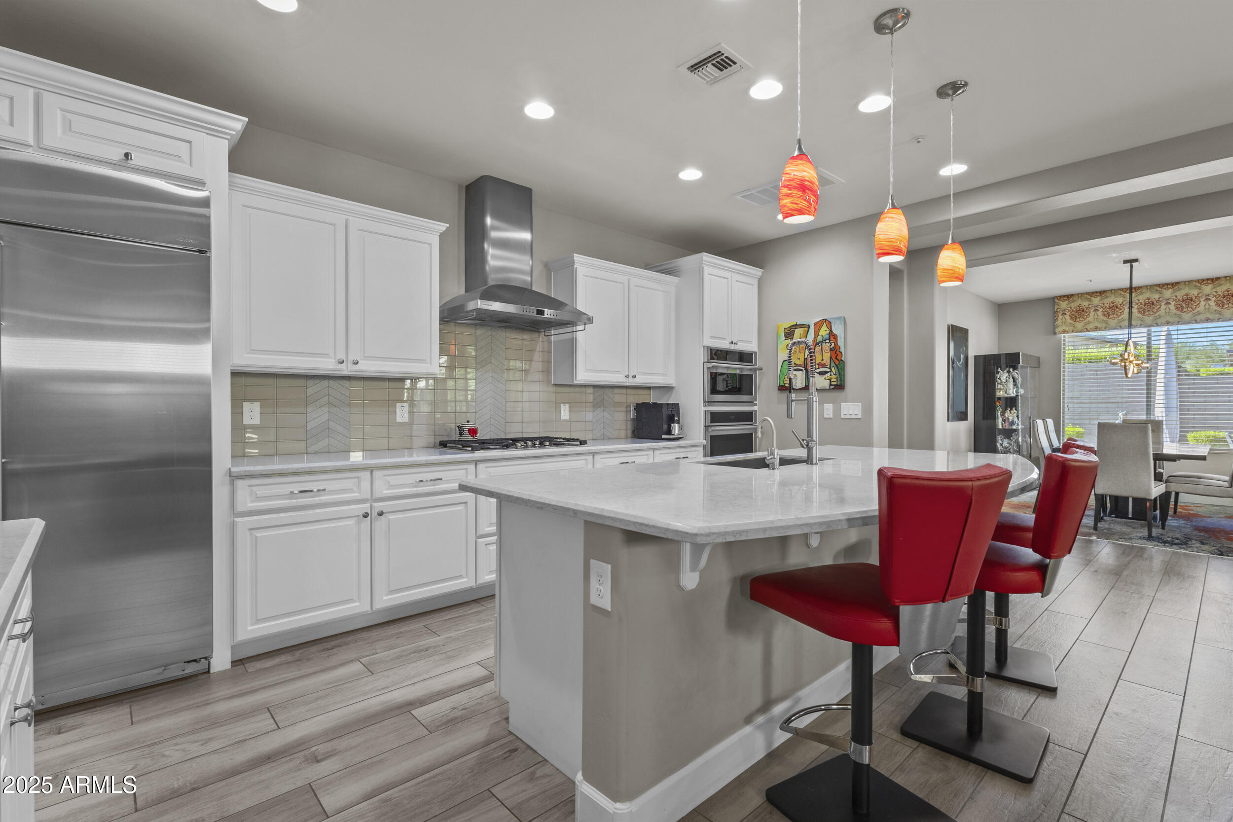 18068 East Curva De Plata Rio Verde, AZ 85263 - Photo 24 of 71 a kitchen with stainless steel appliances granite countertop a white cabinets and chairs