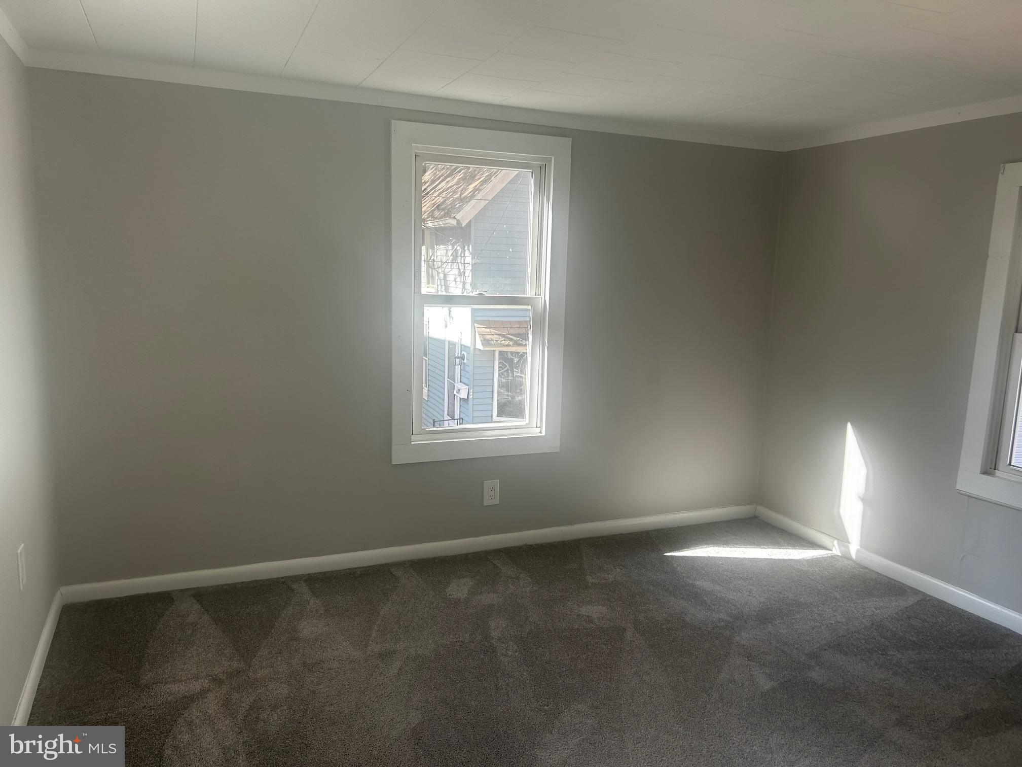 106 9th Avenue Pitman, NJ 08071 - Photo 8 of 14 an empty room with a window