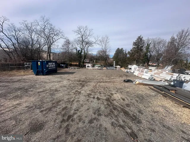 a view of a dirt road with a building