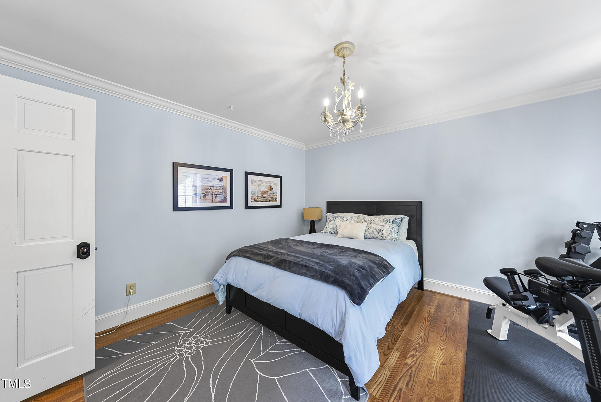 513 Lake Boone Trail Raleigh, NC 27608 - Photo 22 of 41 a spacious bedroom with a bed and a chandelier