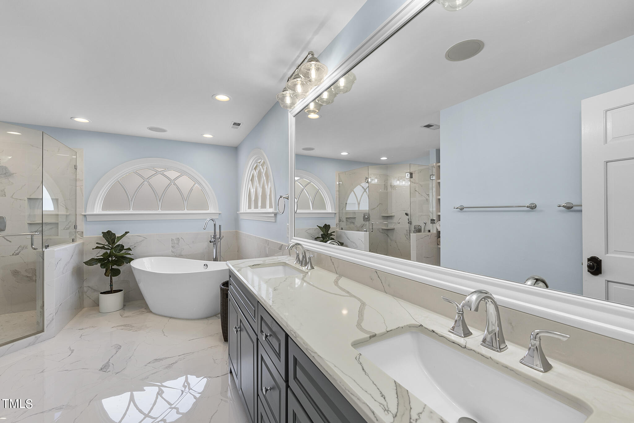 513 Lake Boone Trail Raleigh, NC 27608 - Photo 25 of 41 a bathroom with a double vanity sink a mirror and a bathtub