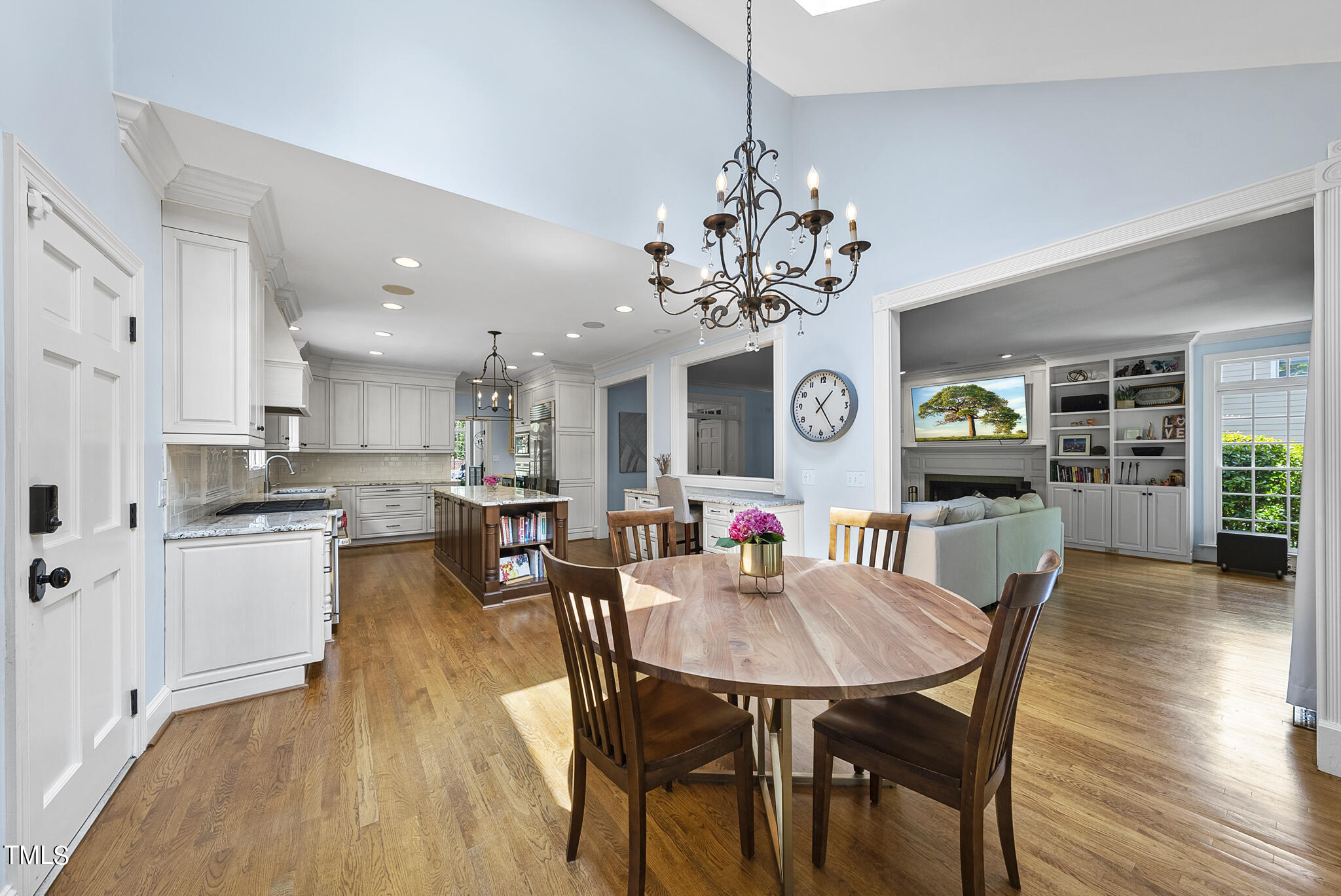 513 Lake Boone Trail Raleigh, NC 27608 - Photo 30 of 41 a view of a dining room and livingroom with furniture wooden floor a chandelier
