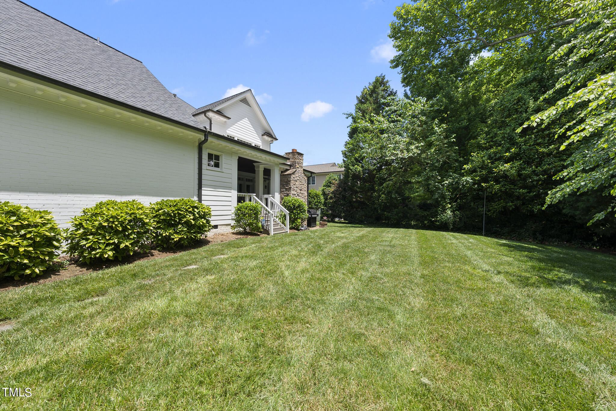 513 Lake Boone Trail Raleigh, NC 27608 - Photo 34 of 41 a view of a backyard with plants and large trees