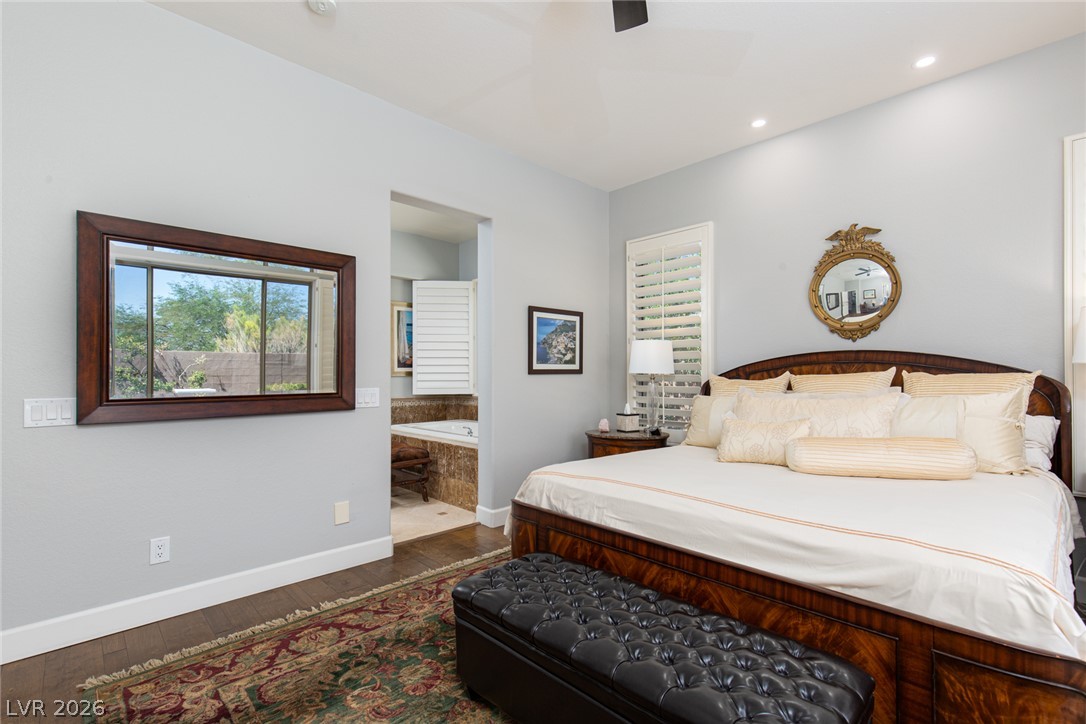 22 Douglas Grove Road Henderson, NV 89052 - Photo 35 of 72 Hardwood floors and bright recessed lighting illuminate this restful sleeping area with an adjacent spa bath.