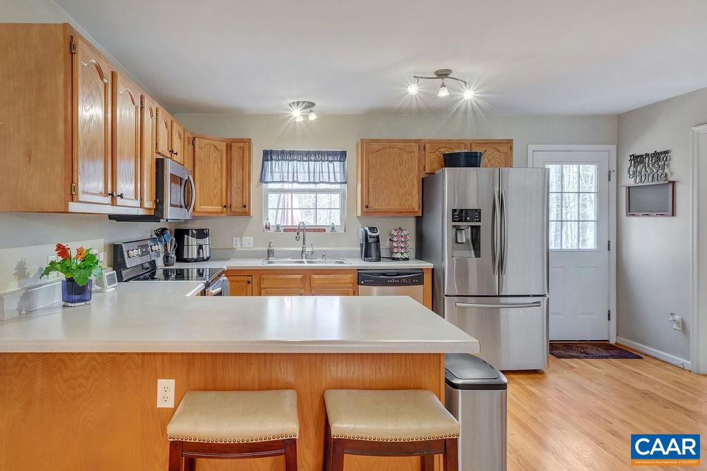 13 Stonewall Road Palmyra, VA 22963 - Photo 12 of 45 a kitchen with stainless steel appliances a dining table chairs refrigerator and sink
