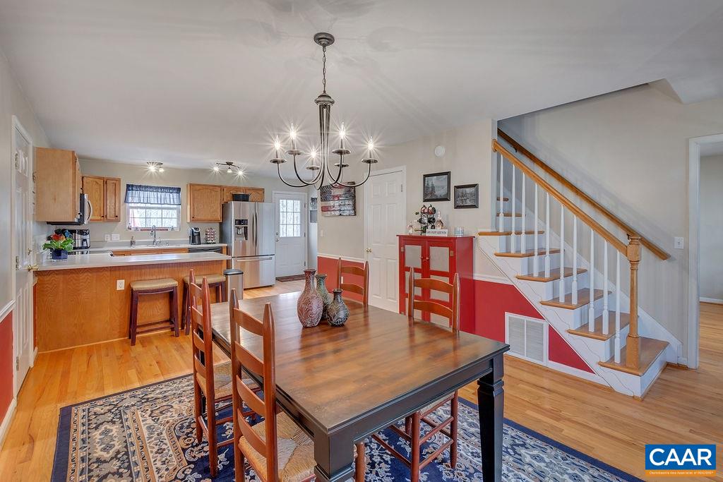 13 Stonewall Road Palmyra, VA 22963 - Photo 14 of 45 a dining room with furniture a chandelier and wooden floor