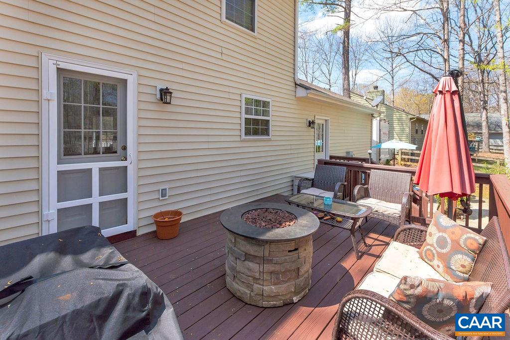 13 Stonewall Road Palmyra, VA 22963 - Photo 28 of 45 a view of a deck with couches table and chairs with wooden floor and fence