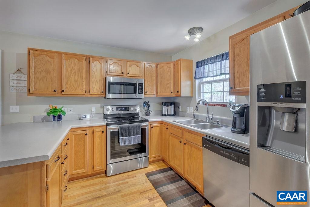 13 Stonewall Road Palmyra, VA 22963 - Photo 10 of 45 a kitchen with stainless steel appliances granite countertop a stove a sink a refrigerator a microwave a sink and cabinets