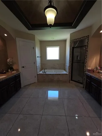 a view of a livingroom with a chandelier furniture and windows