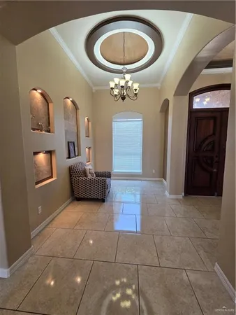 a living room with furniture and a gym machine