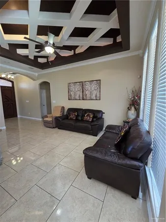 a living room with furniture and ceiling fan