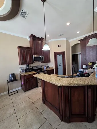 a kitchen with stainless steel appliances granite countertop a refrigerator and a sink