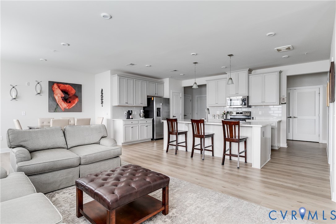 3900 Maze Runner Drive, Unit 206 Midlothian, VA 23112 - Photo 11 of 26 a living room with furniture and kitchen view