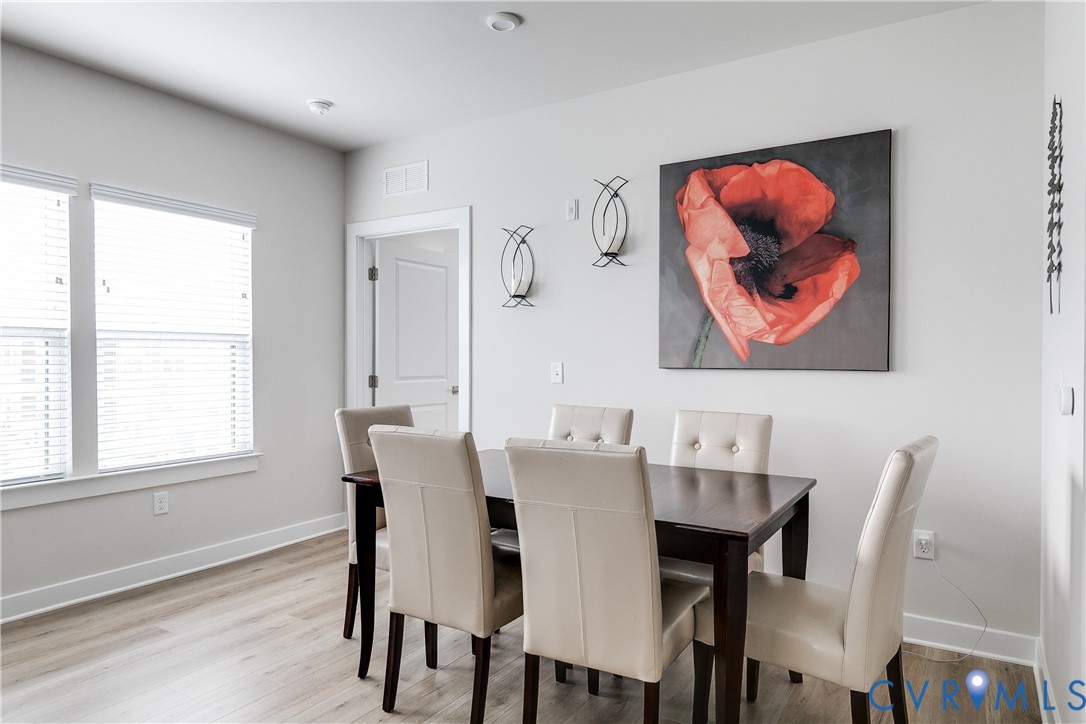 3900 Maze Runner Drive, Unit 206 Midlothian, VA 23112 - Photo 12 of 26 a view of a dining room with furniture window and wooden floor