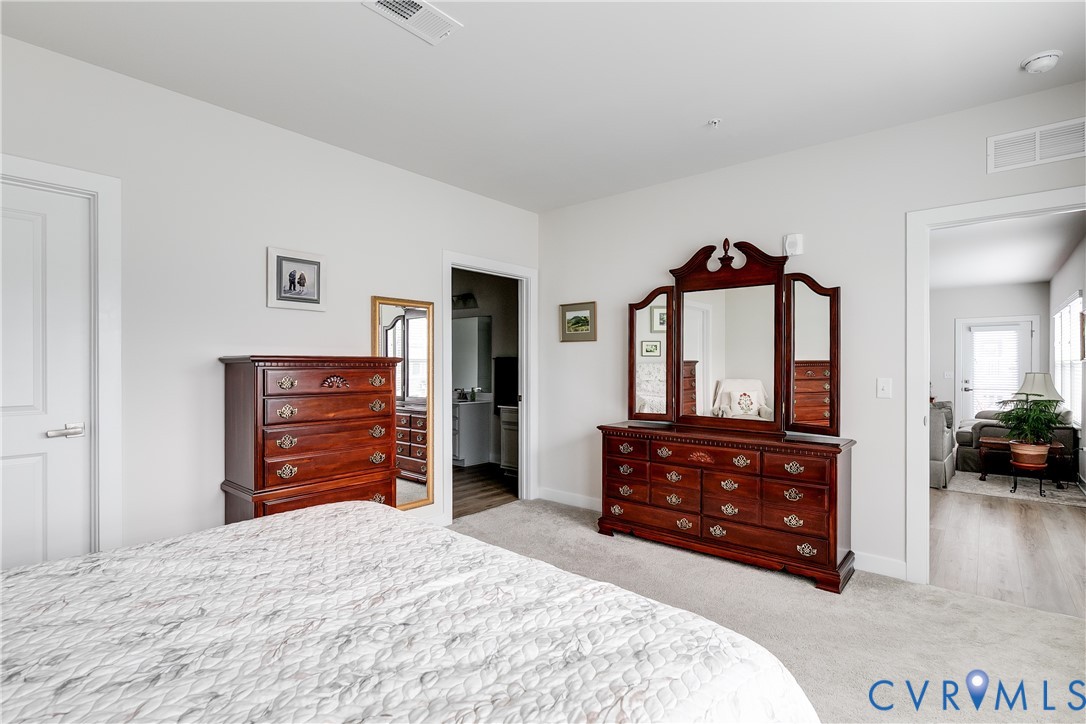 3900 Maze Runner Drive, Unit 206 Midlothian, VA 23112 - Photo 15 of 26 a bedroom with a bed and a dresser