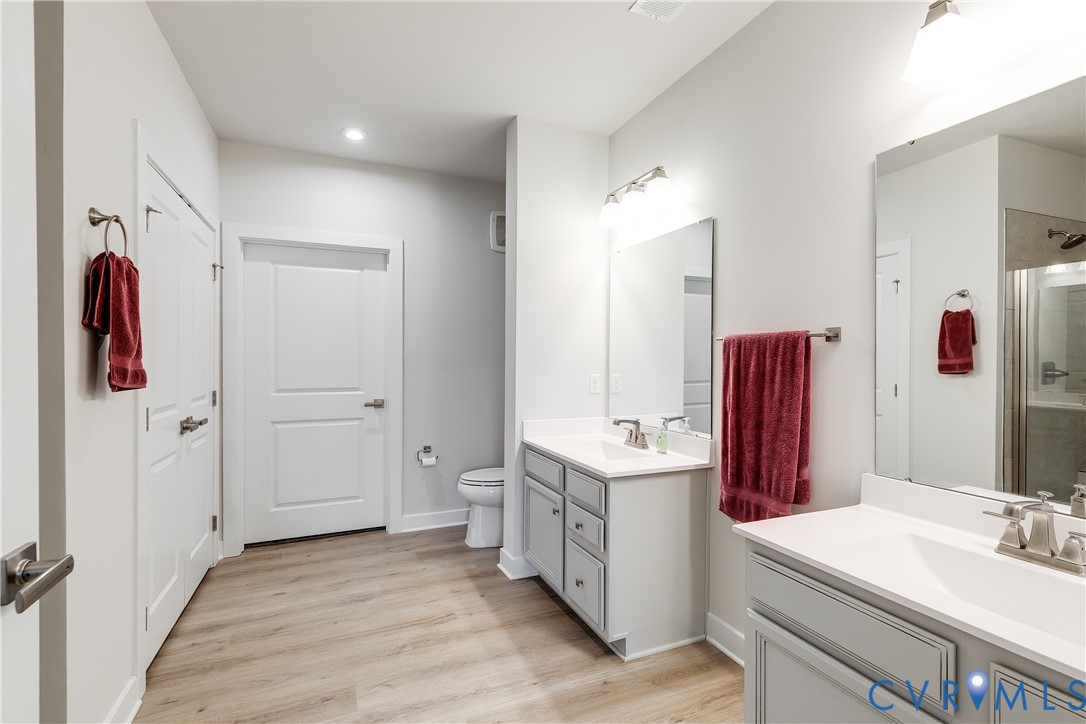 3900 Maze Runner Drive, Unit 206 Midlothian, VA 23112 - Photo 16 of 26 a bathroom with a double vanity sink mirror and shower