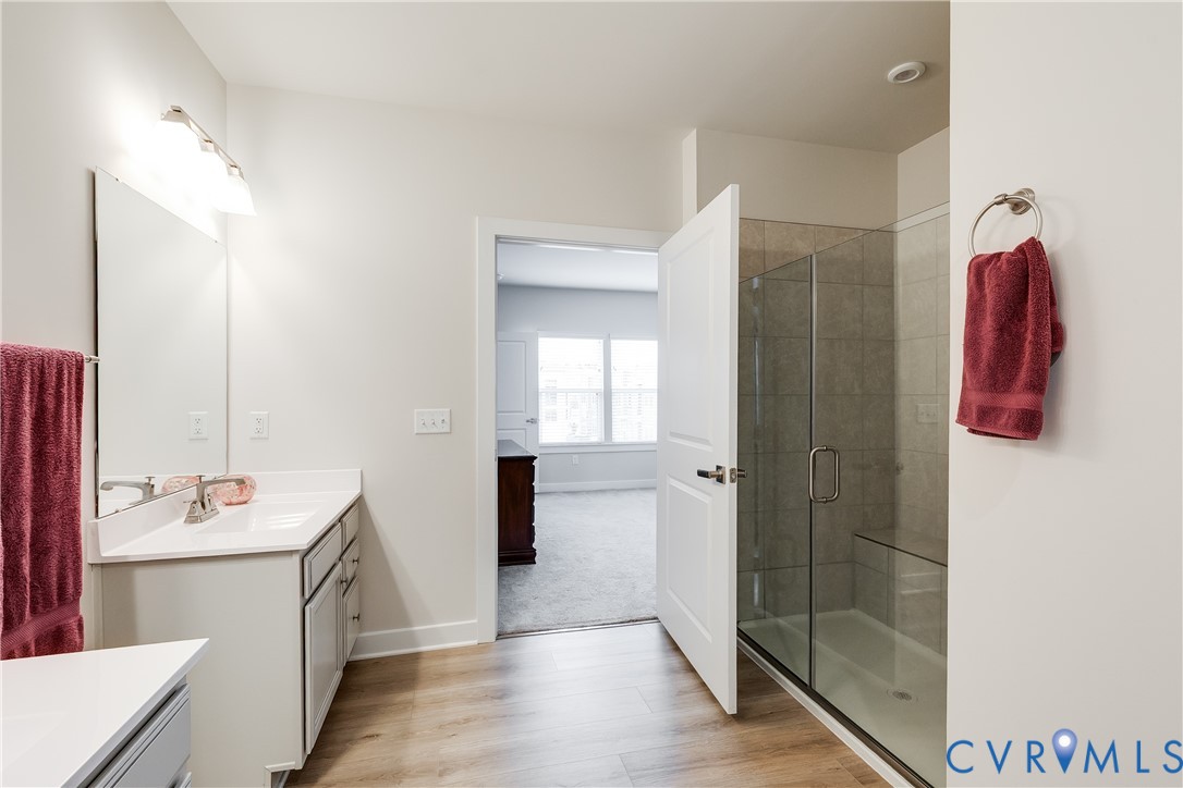 3900 Maze Runner Drive, Unit 206 Midlothian, VA 23112 - Photo 17 of 26 a bathroom with a double vanity sink a toilet and shower