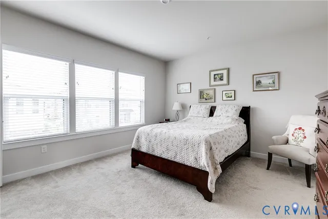 a spacious bedroom with a bed and a window