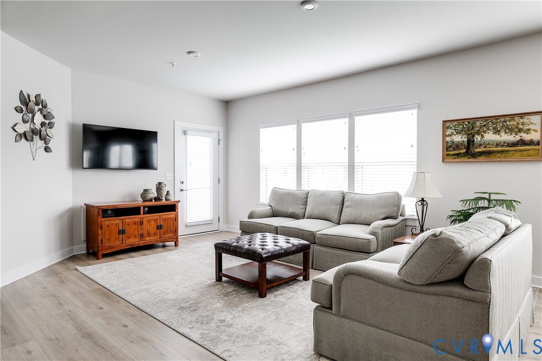 3900 Maze Runner Drive, Unit 206 Midlothian, VA 23112 - Photo 4 of 26 a living room with furniture and a flat screen tv
