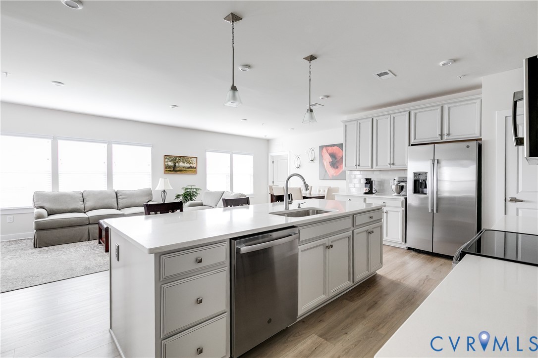3900 Maze Runner Drive, Unit 206 Midlothian, VA 23112 - Photo 8 of 26 a kitchen with white cabinets and stainless steel appliances