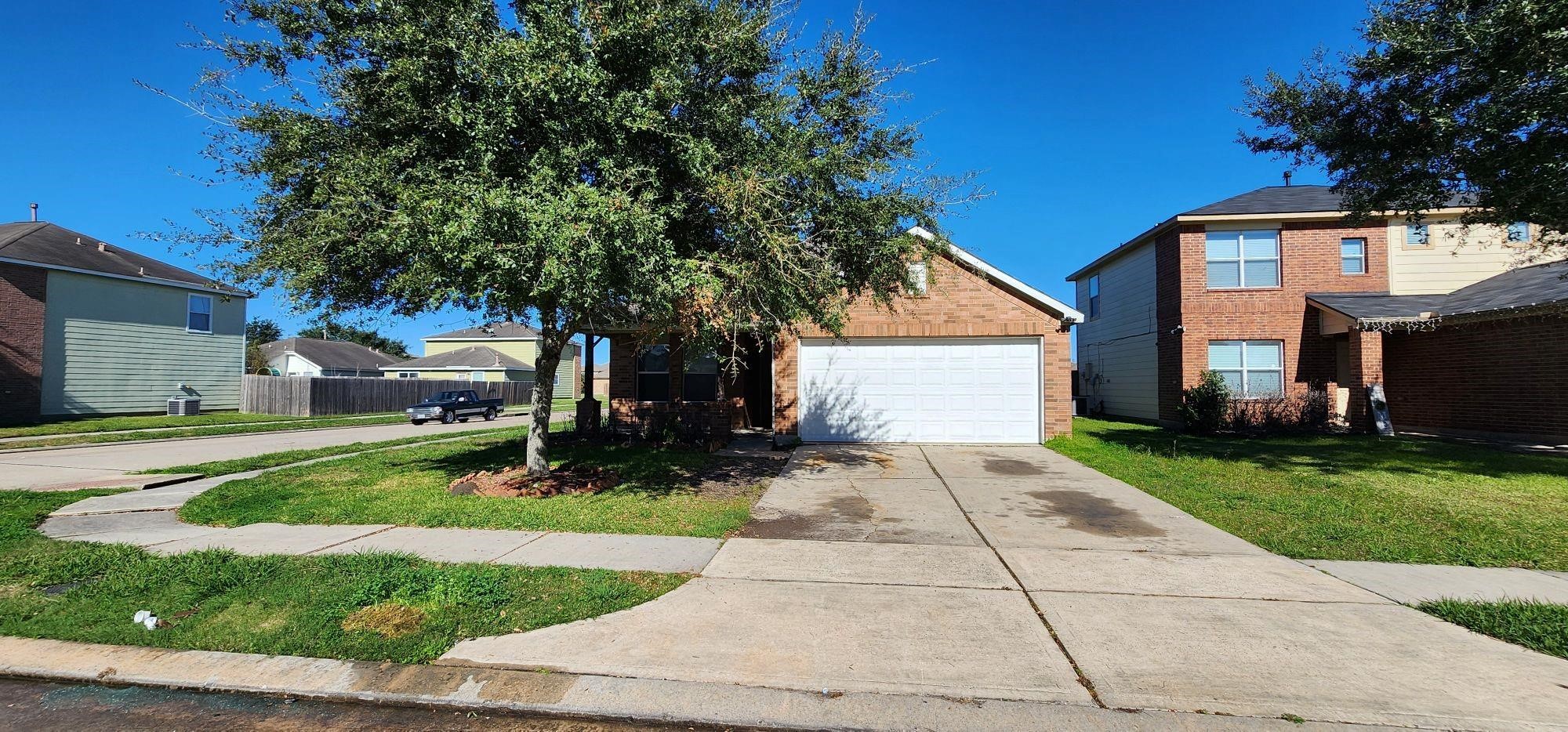 315 Sunset Colony Drive Rosharon, TX 77583 - Photo 1 of 20 a front view of a house with a yard and a garage