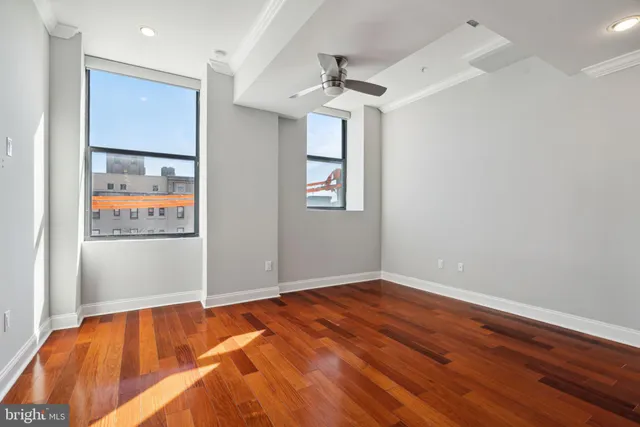 a view of a room with wooden floor and window