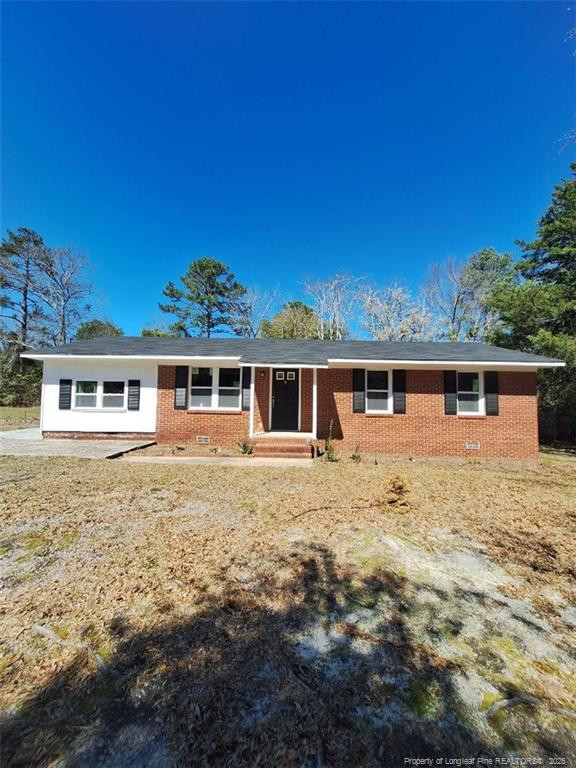 427 Jones Avenue Raeford, NC 28376 - Photo 2 of 15 a front view of a house with a garden