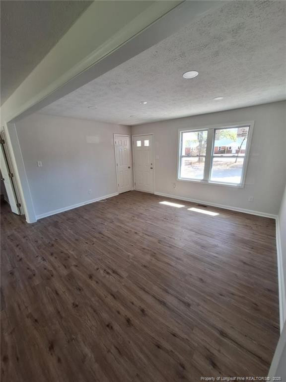 427 Jones Avenue Raeford, NC 28376 - Photo 4 of 15 an empty room with wooden floor and windows