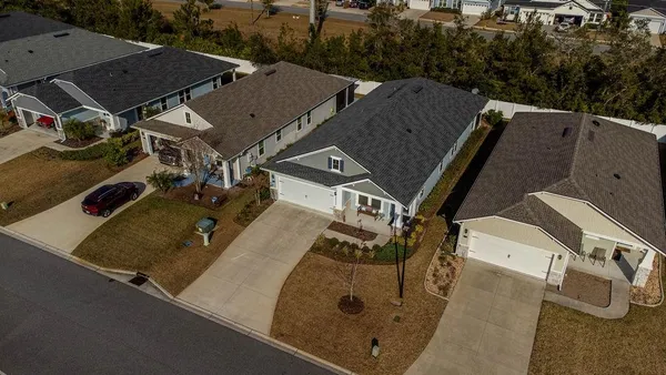 an aerial view of a house with a yard