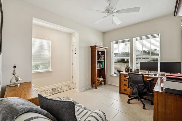 a livingroom with workspace and a window