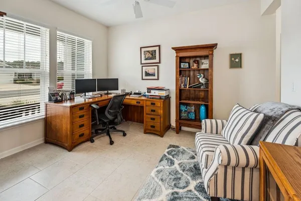 a view of a livingroom with workspace and a window
