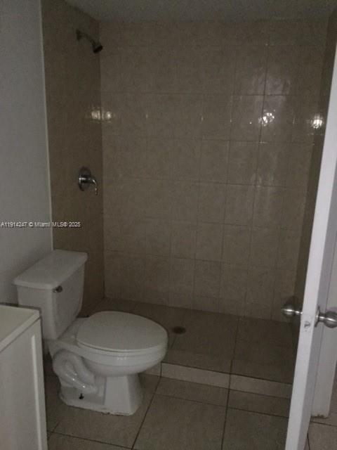17580 Northwest 67th Place, Unit F1 Hialeah, FL 33015 - Photo 12 of 14 a white toilet sitting next to a bathroom sink and vanity
