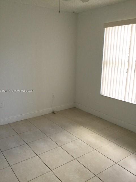 17580 Northwest 67th Place, Unit F1 Hialeah, FL 33015 - Photo 14 of 14 an empty room with a window