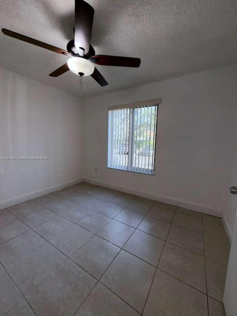 17580 Northwest 67th Place, Unit F1 Hialeah, FL 33015 - Photo 6 of 14 a view of an empty room with a window