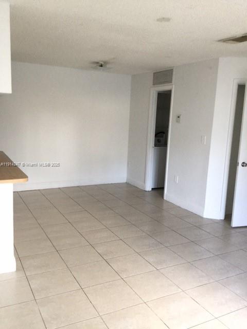 17580 Northwest 67th Place, Unit F1 Hialeah, FL 33015 - Photo 8 of 14 an empty room with a bench