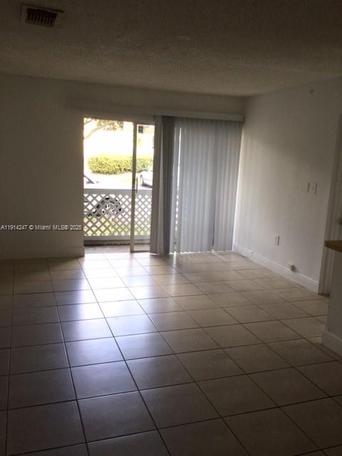17580 Northwest 67th Place, Unit F1 Hialeah, FL 33015 - Photo 9 of 14 a view of an empty room with a window