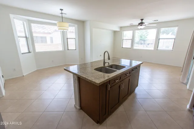 a large kitchen with stainless steel appliances a stove a sink and a refrigerator